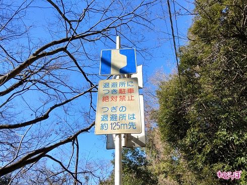 「駐車絶対禁止」。行政とは思えない強い文章。次の退避所までの距離をわざわざ教えてくれる親切さ。この道路にはいったい何が……!?