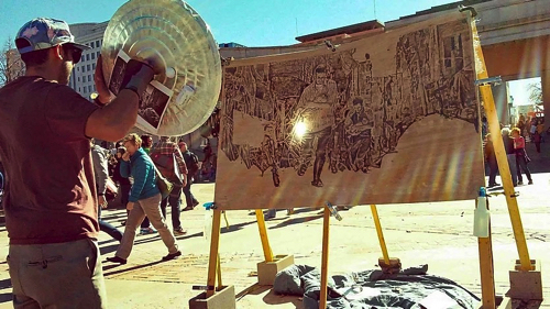 レンズで太陽光を集熱させて描くアート