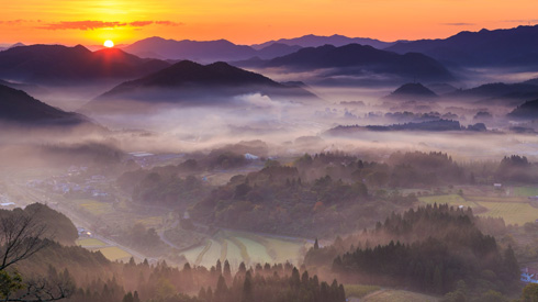 山に薄い霧がかかっている写真