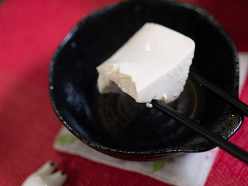 箸で絹豆腐を持ち上げるところ