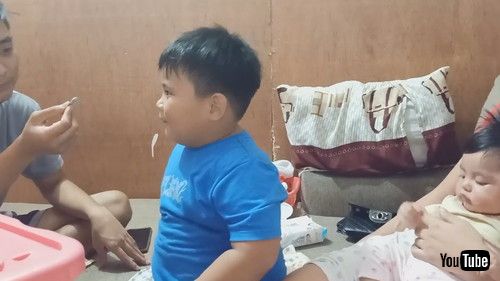 「Boy Watches in Amazement While Sibling Performs Magic Trick - 1205861」