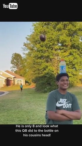 「Talented Boy Hits Bottle Balancing on Top of Cousin's Head Standing Several Feet Away - 1268460」