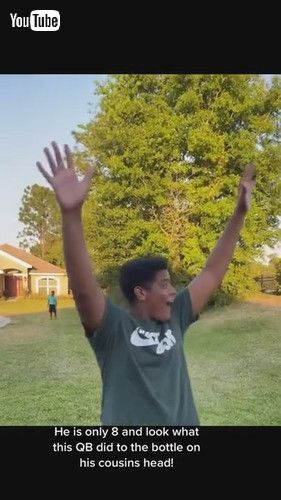 「Talented Boy Hits Bottle Balancing on Top of Cousin's Head Standing Several Feet Away - 1268460」