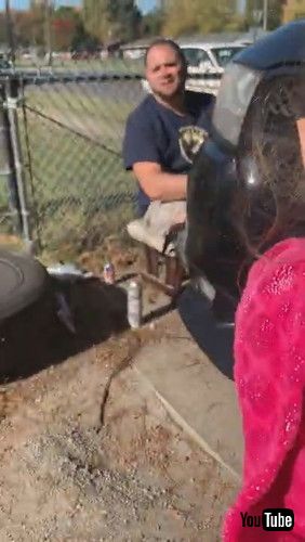 「Little Kid Draws On Mother's Car With Screwdriver While Father Works Nearby - 1269650」