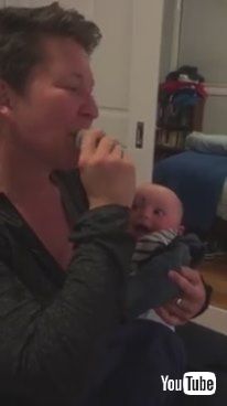 「Baby Laughs at Mom Putting Pacifier in Mouth - 985799」