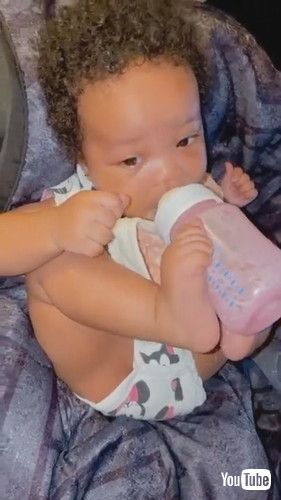 「Toddler Drinks Milk From Bottle While Holding it With Feet - 1278029」