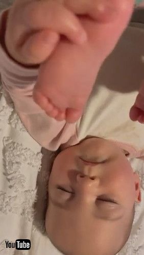 「Baby Falls Asleep Holding Her Feet || ViralHog」