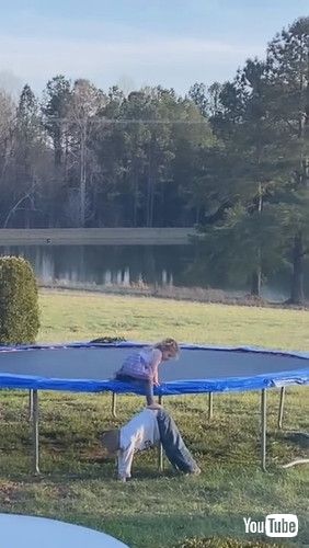 「Kid Bends Down to Let Sister Climb Down from Trampoline - 1304263」