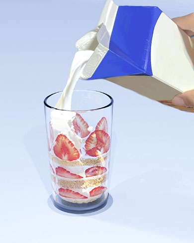 ショートケーキが描かれたグラスに牛乳を注ぐ