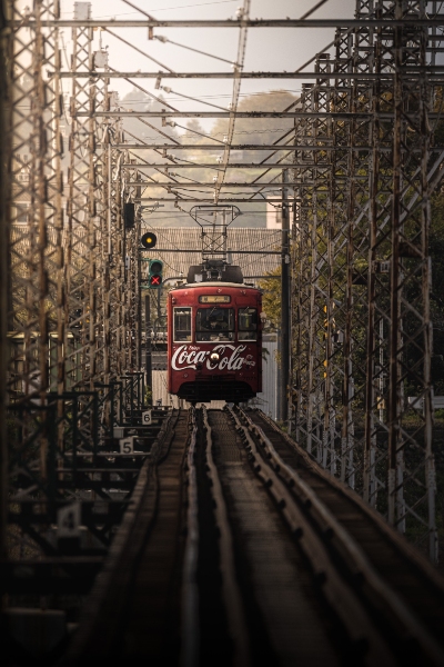 セピア色の世界を走る「コカ・コーラ」ラッピングの電車