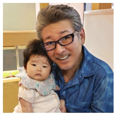 初孫を抱く布川敏和
