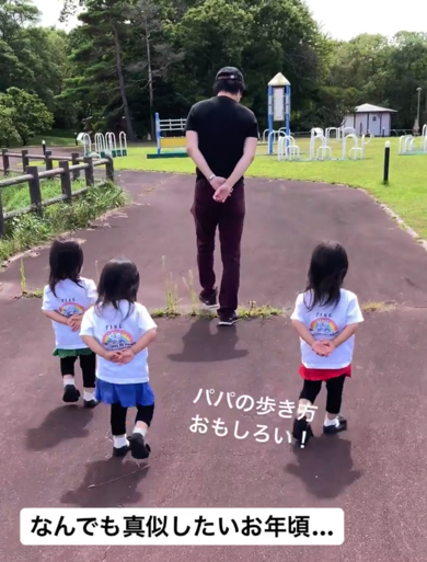 パパのまねをする三つ子たちの後ろ姿