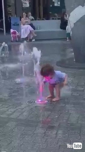 「Toddler Gets Scared of Water Gushing Out of Fountain - 1371235」