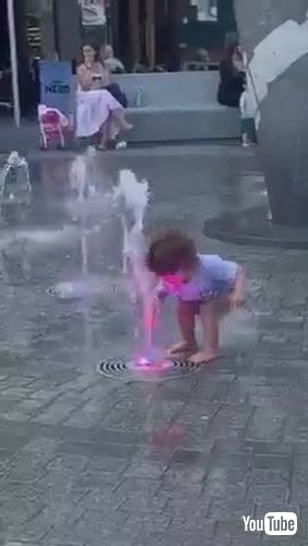 「Toddler Gets Scared of Water Gushing Out of Fountain - 1371235」