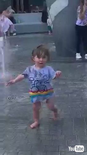 「Toddler Gets Scared of Water Gushing Out of Fountain - 1371235」