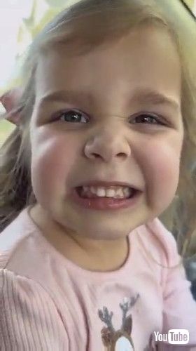 「Little Girl Struggles to Smile While Showing Teeth - 1407529」