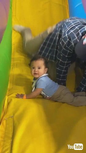 「Father Saves Son From Falling Off Inflatable Slide - 1423773」