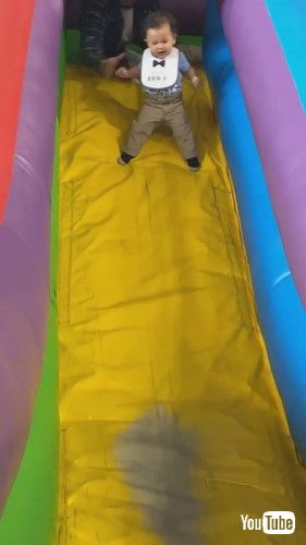 「Father Saves Son From Falling Off Inflatable Slide - 1423773」