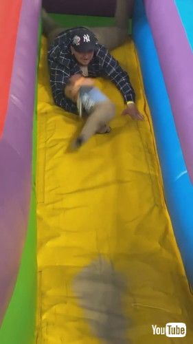 「Father Saves Son From Falling Off Inflatable Slide - 1423773」