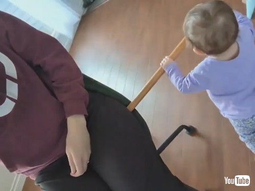 「Toddler Uses Stick to Help Mom Spin on Revolving Chair - 1413227」