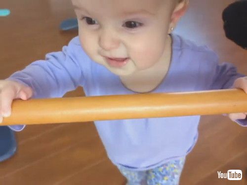 「Toddler Uses Stick to Help Mom Spin on Revolving Chair - 1413227」