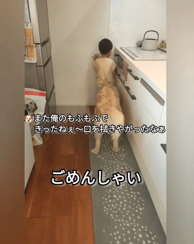 壁の前で背を向ける男の子