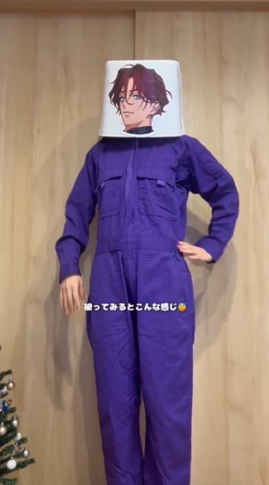 つなぎを着てお面をかぶった女性