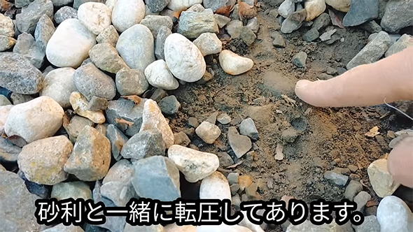 砂利の下の土を指さす