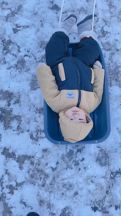 ソリに乗る息子