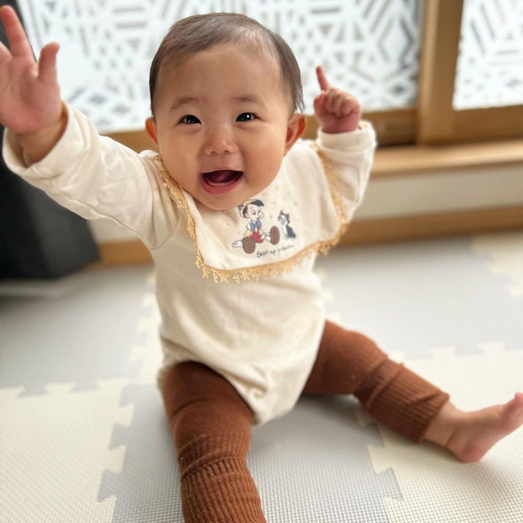 見上げてほほ笑む赤ちゃん