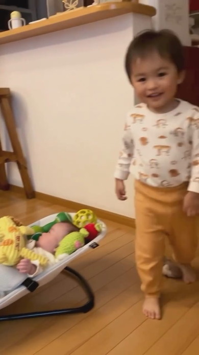 赤ちゃんの周りにおもちゃを置くお兄ちゃん