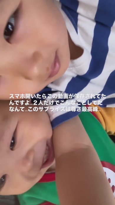 パパのスマートフォンで自撮りをする幼い兄弟の姿