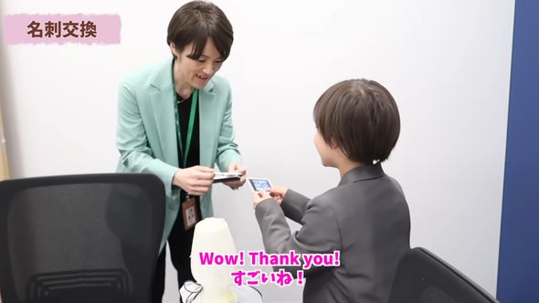 自身のアイデアをプレゼンテーションする前にフィリップスの社員と名刺交換する9歳の男の子