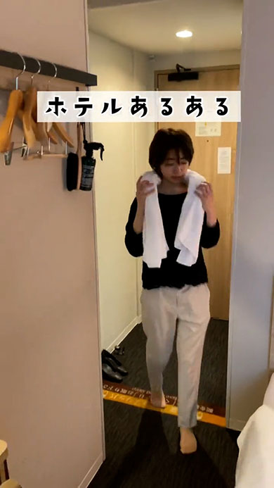 ホテルあるある・タオルを首にかけた女性