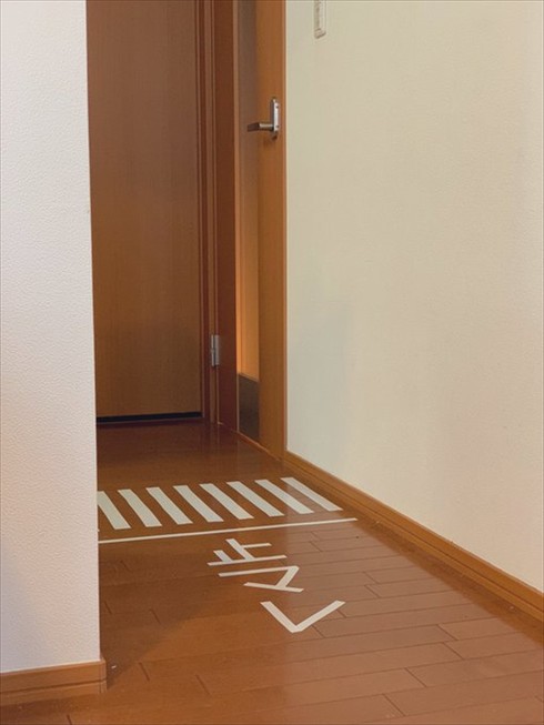 自宅の廊下にビニールテープで作った止マレサイン