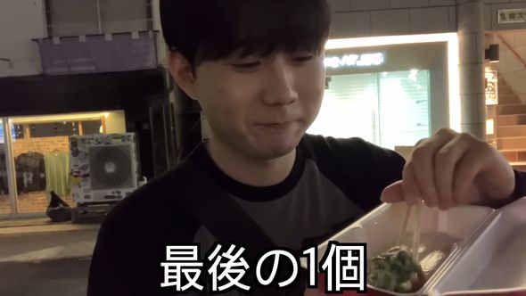名残惜しそうに最後のたこ焼きを食べる韓国人男性