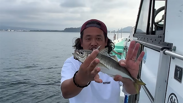 アジを両手で支えて見せる