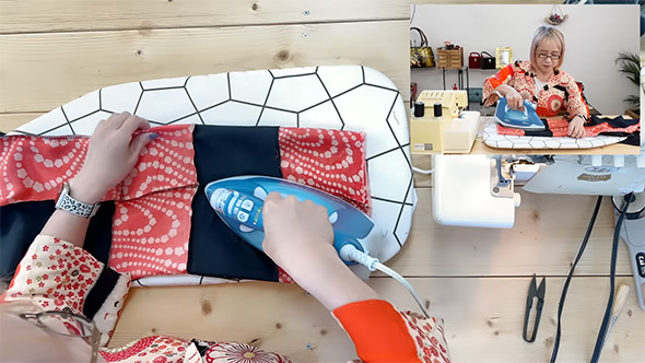 輪になった布にアイロンをあてる