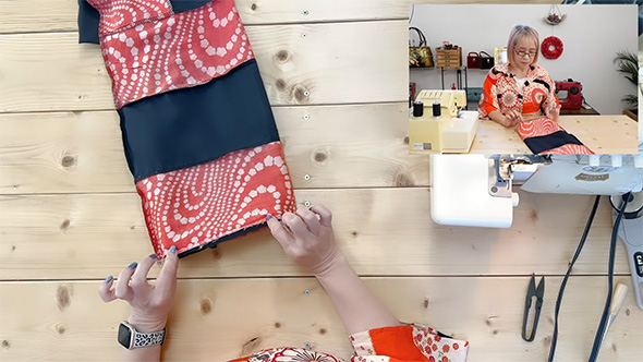 輪になった布の端をつまむ