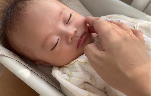 体重計の上で眠る赤ちゃん