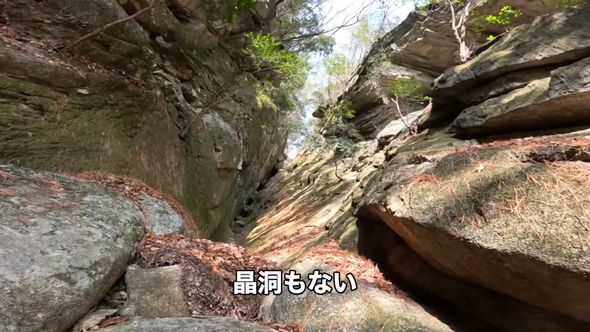 鉱物を探して険しい岩山を登る