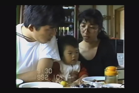 1歳の女の子を両親で挟んだ食事の光景