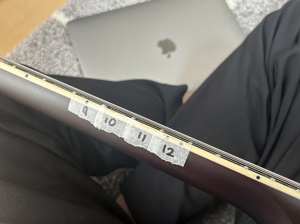 ギターの指板に貼られてるフレットの番号を記したテープ