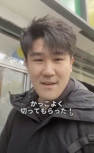 カットが終わった男性が自撮りしている様子。「かっこよく切ってもらった！」とテロップが表示されている