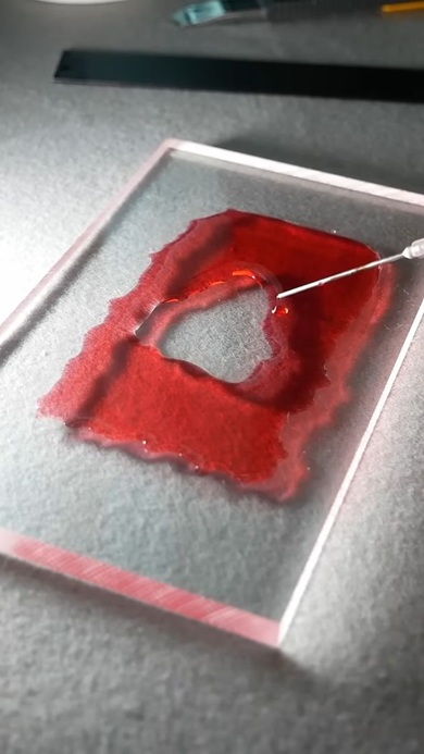 アクリルパネル上に形作られていくYouTubeマーク