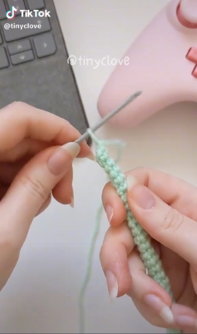 毛糸を細長い紐状に編む様子