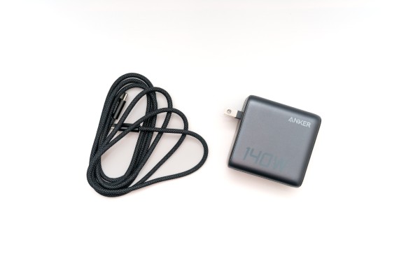 Anker 140W充電器と黒いUSB-Cケーブルのセット。白背景で、ケーブルは左、充電器は右に配置。
