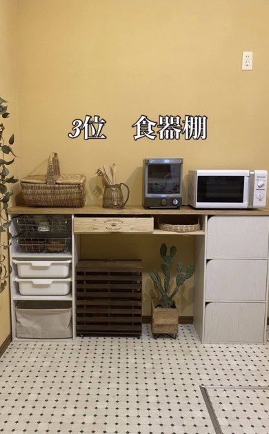 「3位 食器棚」と書かれた画像。左側に白い収納ボックスとバスケット、中央に木製の箱と植物、右側にリメイクされた白いカラボ棚と家電が並ぶ。